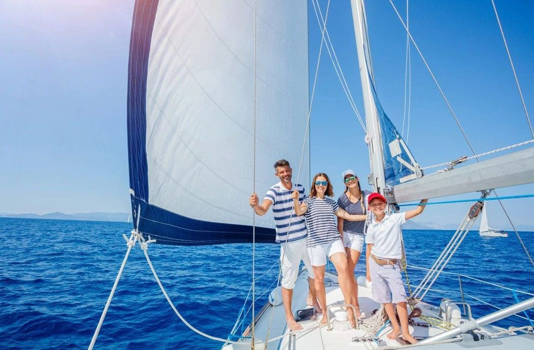 A group of people standing on top of a boat.