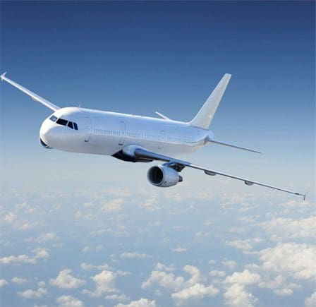 A large white airplane flying through the sky.